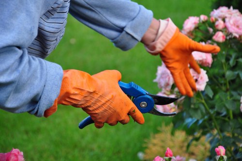 Team member preparing tools on-site for a gardening job